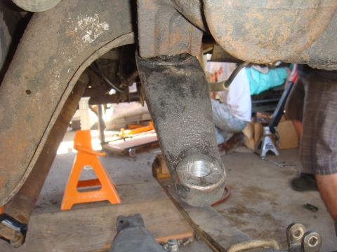 1992 Ford Bronco - Close-up view of vehicle suspension components, with a person working in the background.