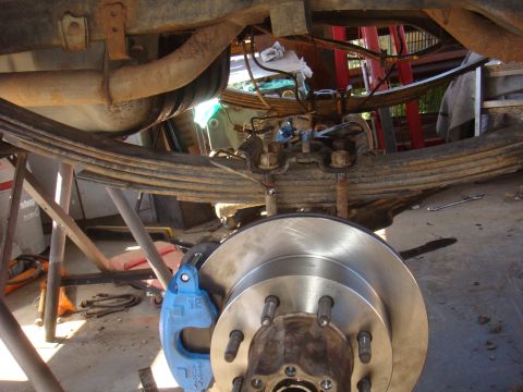 1992 Ford Bronco - Close-up view of a vehicle's rear axle and suspension system during maintenance.
