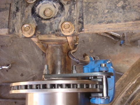 1992 Ford Bronco - A close-up view of a vehicle's brake caliper and rotor assembly, likely part of an axle build.