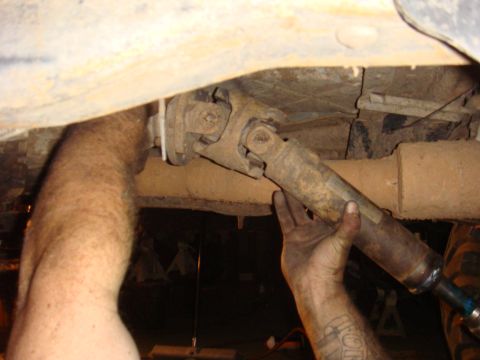 1992 Ford Bronco - Close-up of a vehicle's undercarriage, focusing on a driveshaft and exhaust system.