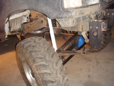 1992 Ford Bronco - Front suspension and tire of a 1992 Ford Bronco, showing modifications.