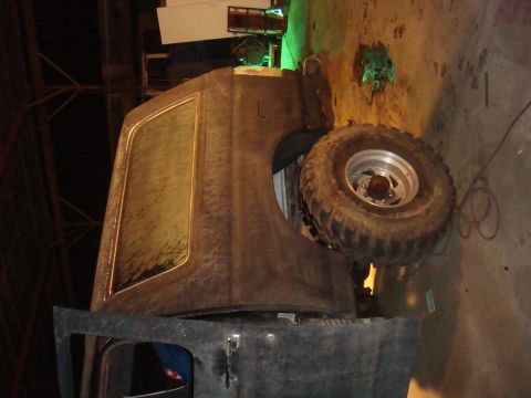 1992 Ford Bronco - This 1992 Ford Bronco is shown from the side, appearing to be in a workshop or garage setting.