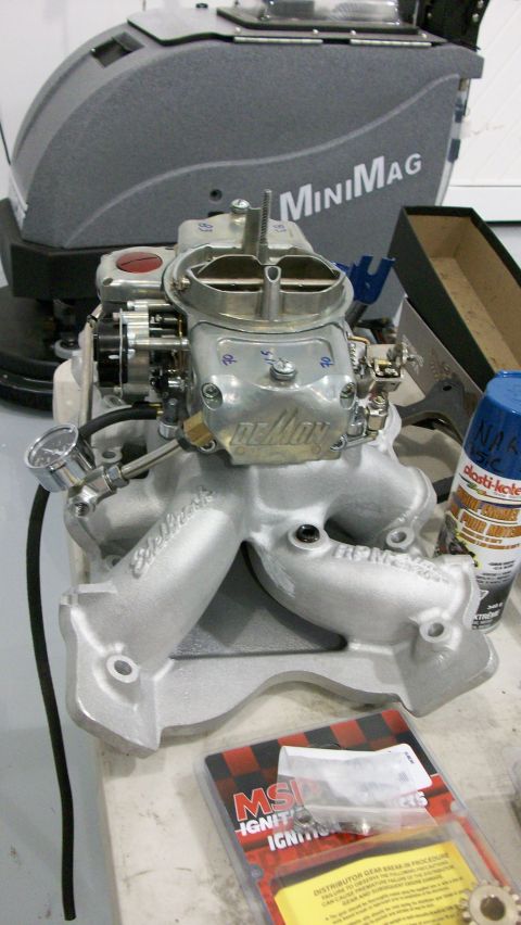 1973 Ford Ranchero - Edelbrock intake manifold and carburetor assembly with associated parts and spray paint.