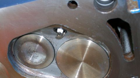 1973 Ford Ranchero - This image shows a close-up view of an engine's cylinder head, focusing on the valves and spark plug area.