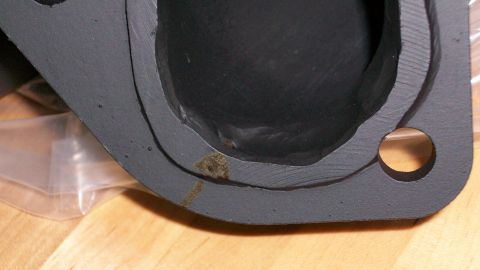 1973 Ford Ranchero - Close-up view of an exhaust manifold gasket surface, showing the machined sealing area and a bolt hole.