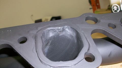 1973 Ford Ranchero - Close-up of a modified engine exhaust manifold, showing port work.