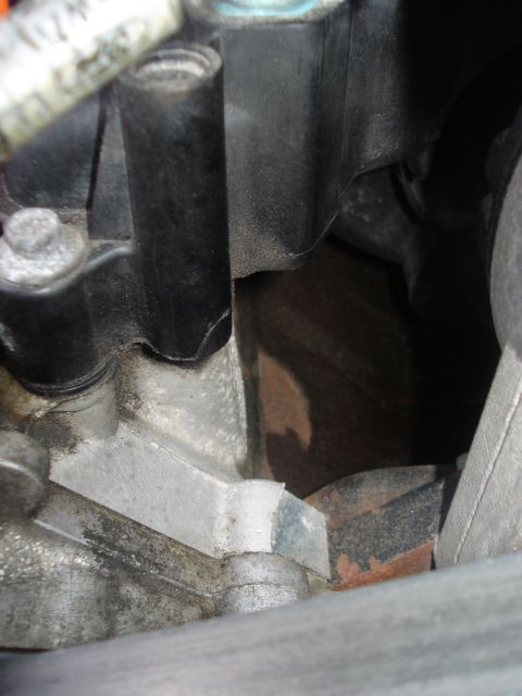 2000 Ford Crown Victoria - Close-up view of an engine component, possibly related to a heater hose, showing various metal and plastic parts.