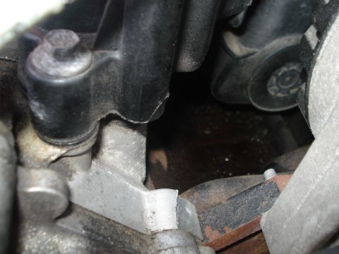 2000 Ford Crown Victoria - Engine compartment detail showing various metal and plastic parts.