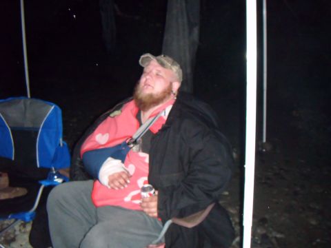 1998 Jeep Cherokee - Man with arm in sling sits in a chair outdoors at night.