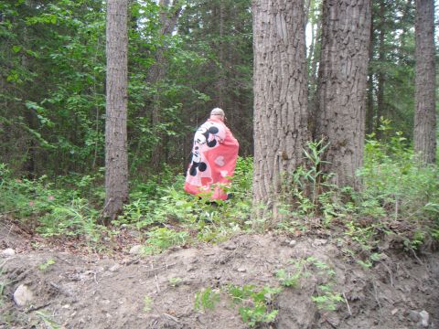 1998 Jeep Cherokee - A person stands in a wooded area, wrapped in a blanket Mickey Mouse.