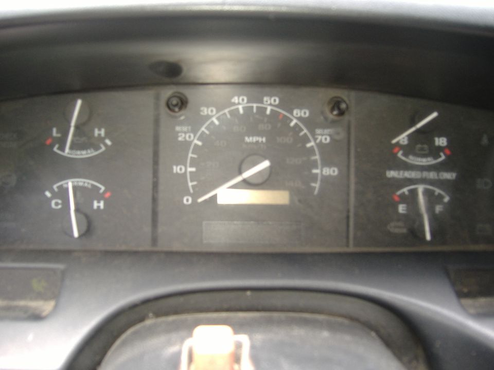 Dashboard with speedometer, fuel gauge, oil pressure, and temperature gauges. Speedometer reads under 20 mph