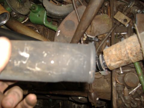 1995 Ford F-150 - A close-up view of a vehicle's exhaust pipe, showing signs of rust and a clamp connection.
