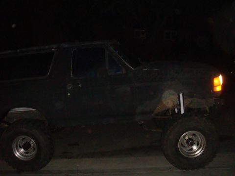 Side view of a black 1992 Ford Bronco with lifted suspension and large tires