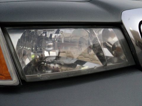 2001 Mercury Grand Marquis - Close-up of a 2001 Mercury Grand Marquis headlight assembly.
