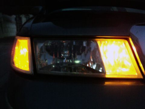 2001 Mercury Grand Marquis - The front passenger side headlight and amber turn signal of a 2001 Mercury Grand Marquis are illuminated.