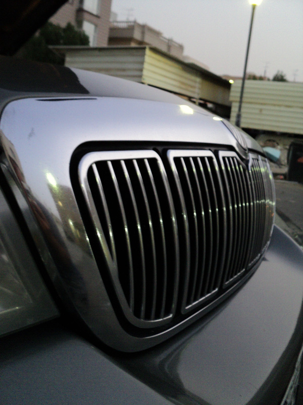 Low-angle close-up of chrome vertical-bar Mercury grille with black recesses