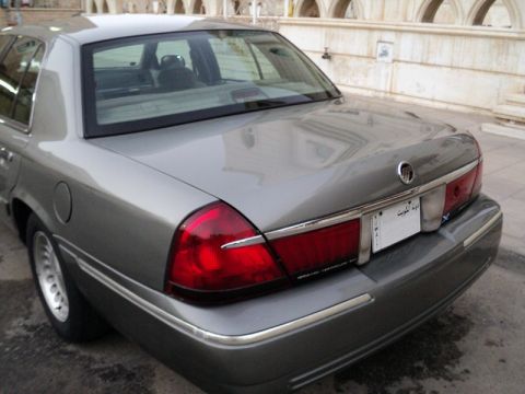 2001 Mercury Grand Marquis - Rear view of a gray 2001 Mercury Grand Marquis sedan, its distinctive taillights and chrome accents.