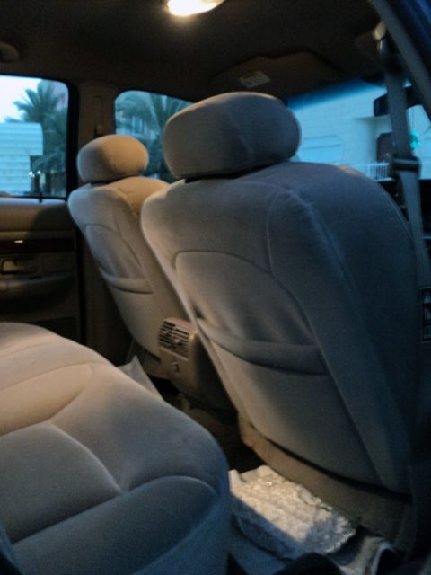 2001 Mercury Grand Marquis - The interior of the vehicle shows the rear seating area with cloth upholstery and headrests.