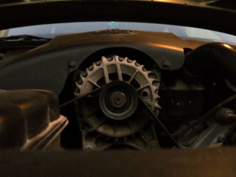 2001 Mercury Grand Marquis - Close-up view of the alternator and drive belt within the engine compartment.