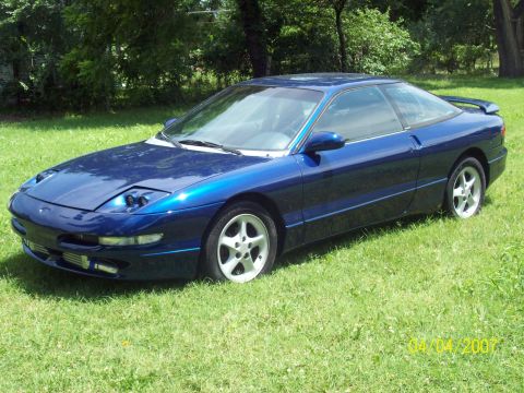 1995 Ford Probe - This 1995 Ford Probe coupe is parked on a grassy lawn with trees in the background.