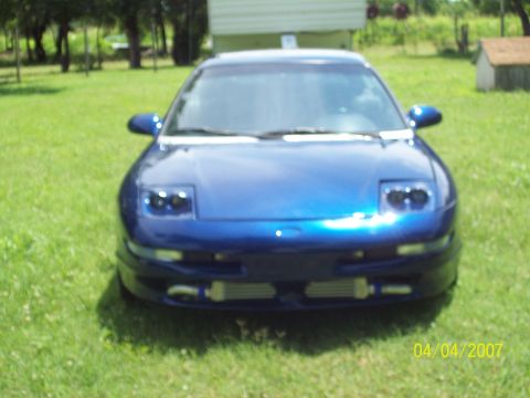 1995 Ford Probe - This blue sports coupe features aftermarket intercoolers, suggesting performance modifications.