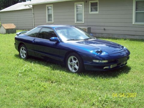 1995 Ford Probe - 1995 Ford Probe parked on the lawn in front of a house.