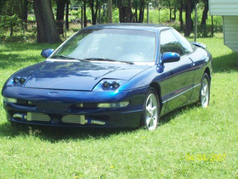 1995 Ford Probe - This blue 1995 Ford Probe features aftermarket intercoolers visible below the front bumper.