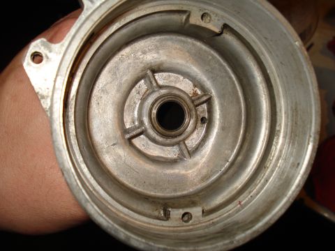 1967 Ford F-250 - Close-up view of a metal distributor housing, showing internal components and wear marks.
