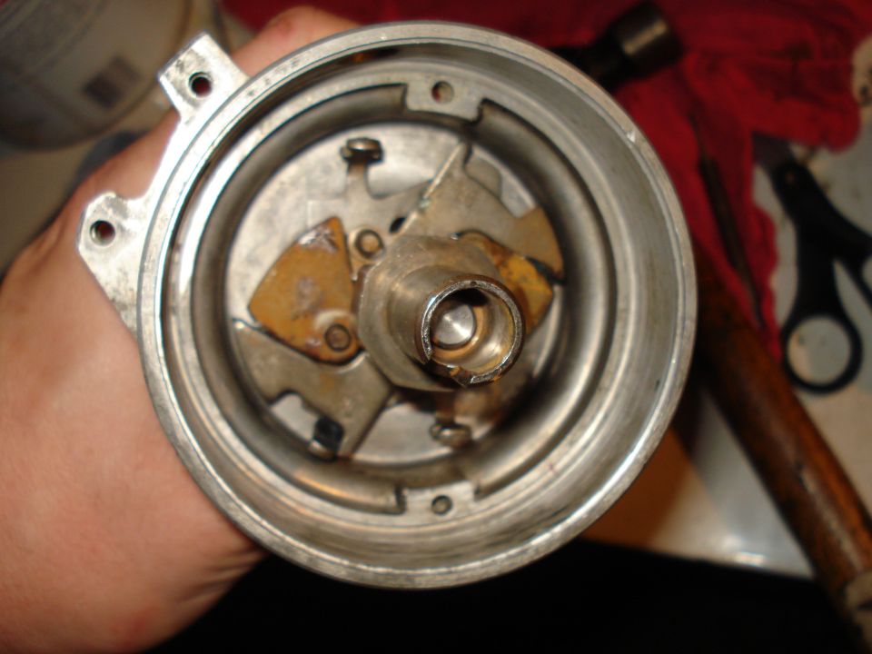 Close-up of the interior of a distributor cap, showing points and rotor mechanism