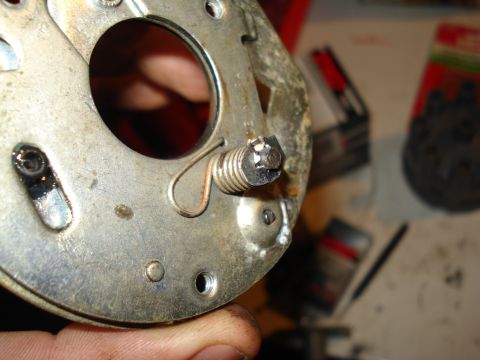 1967 Ford F-250 - Close-up of a metal component, possibly from a vehicle's distributor, with a spring and screw visible.