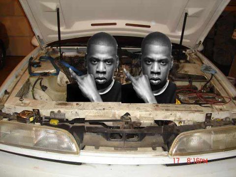 2006 Ford E350 - Two faces of Jay-Z are superimposed in the engine bay of a white vehicle with the hood open.