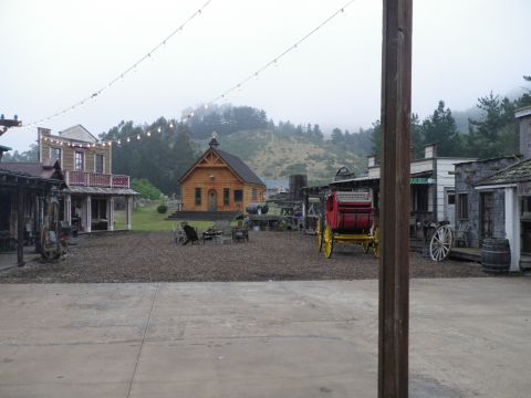 1991 Ford Bronco - A staged western town scene with a church and a carriage is visible under a cloudy sky.