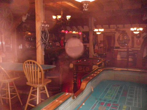 1991 Ford Bronco - A bar scene with pool tables and seating, illuminated by overhead lights.