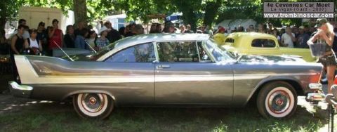 1991 Ford Crown Victoria - A 1957 Plymouth Fury coupe is seen at an outdoor car meet.