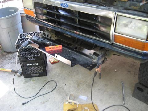 1991 Ford Explorer - Tools and parts are laid out for a repair on the front of a Ford truck, possibly an older Bronco or F-series.