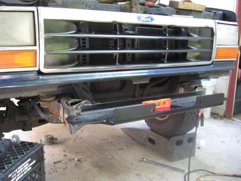 1991 Ford Explorer - The front grille and bumper assembly of a 1991 Ford Explorer is shown, with the Ford logo clearly visible on the grille.