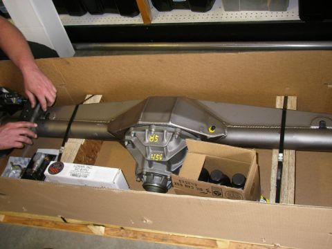 1990 Ford Bronco - A differential axle assembly is secured in a wooden crate with straps and wooden blocks.