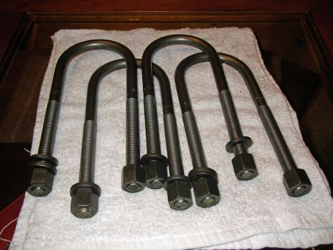 1990 Ford Bronco - Five U-bolts with hardware are laid out on a towel.