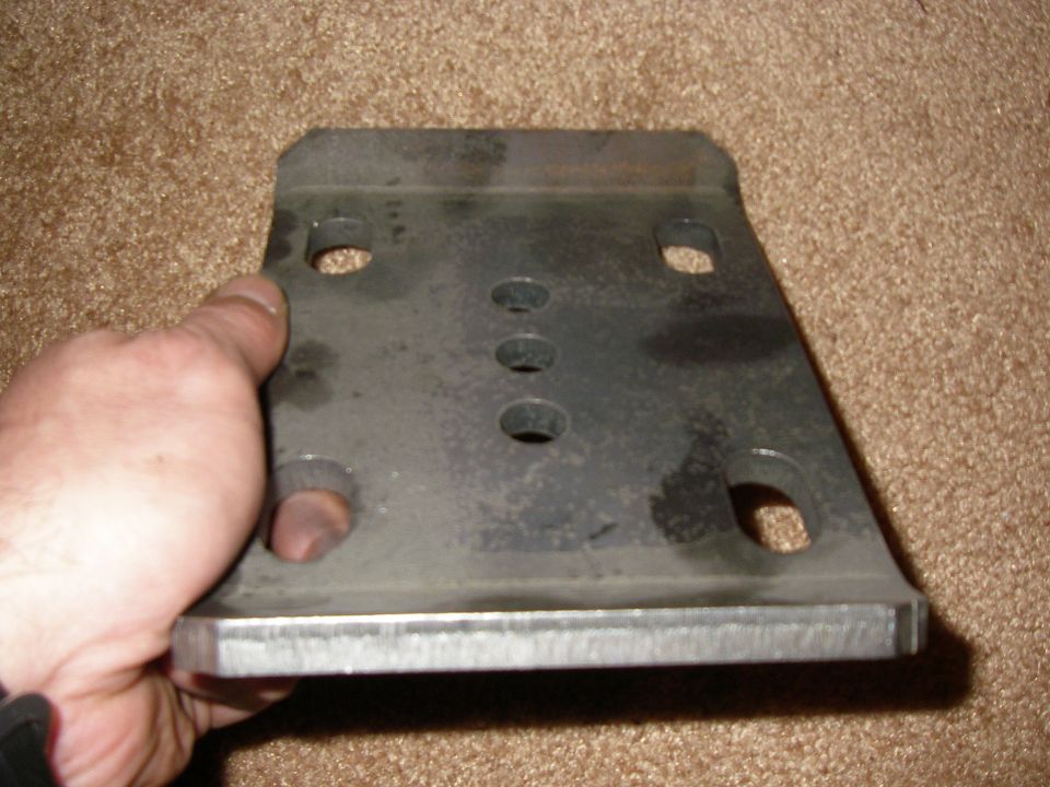 hand holding metal bracket with multiple holes