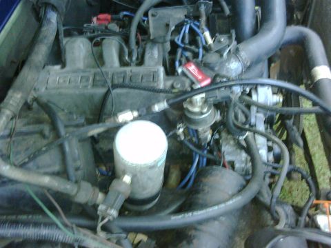 1991 Ford Bronco - Close-up view of an engine bay, showing various mechanical parts and wiring.