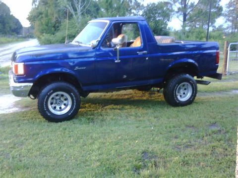 1991 Ford Bronco - This blue 1991 Ford Bronco is shown in a three-quarter front view.