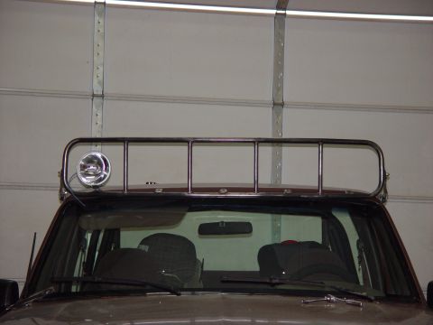 1993 Ford Bronco - The vehicle's roof is equipped with a rack and a spotlight, seen from the front.