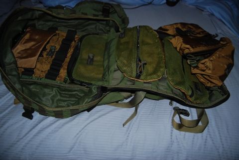 1991 Ford Bronco - An open tactical backpack displays its various compartments, including mesh pockets and tan fabric inserts.