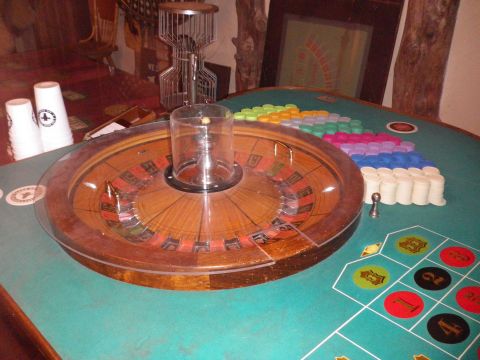 1991 Ford Bronco - Roulette wheel and betting layout with stacks of chips on a green felt table.