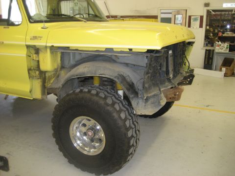 1978 Ford Bronco - This yellow 1978 Ford Bronco is shown from the front quarter with its fender removed, revealing its off-road tires and suspension.