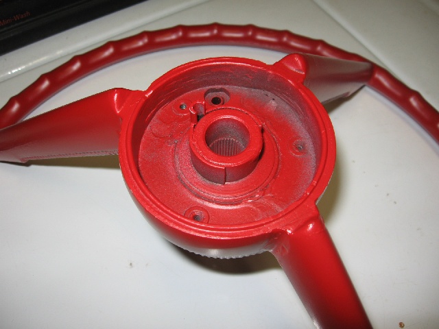 Red steering wheel hub and spokes, showing splined shaft opening