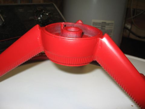 1966 Ford F-100 - Close-up of a red steering wheel hub, possibly undergoing restoration.