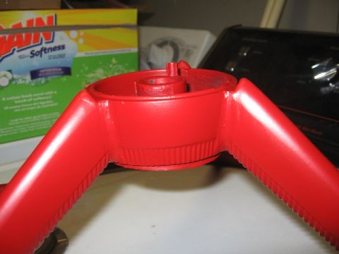 1966 Ford F-100 - Close-up of a red steering wheel hub, likely a replacement part, with a box of laundry detergent in the background.