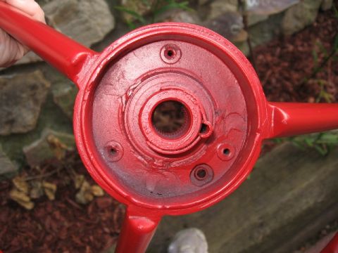 1966 Ford F-100 - Close-up of a red painted steering wheel hub, showing the splined shaft opening.
