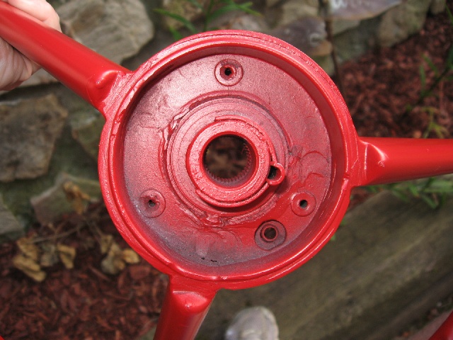 Red painted steering wheel hub with splined shaft opening